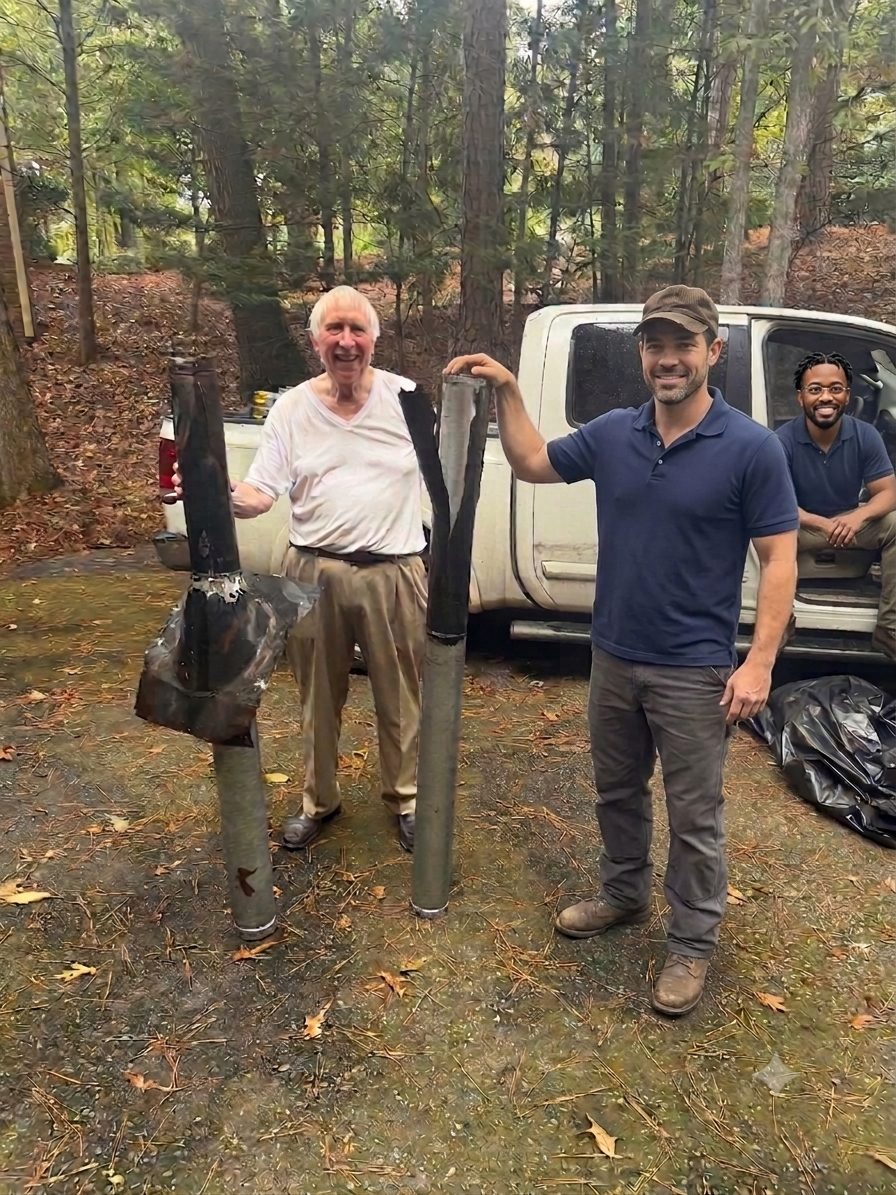 Larry standing with the Yes We Clean crew beside his old corroded furnace chimney stacks before replacement